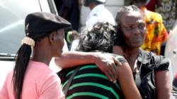 The mother of murder victim Stephanie Daniel (centre) consoles another of her daughters outside the High Court in Kingstown on Friday, June 7, 2013. (IWN photo)