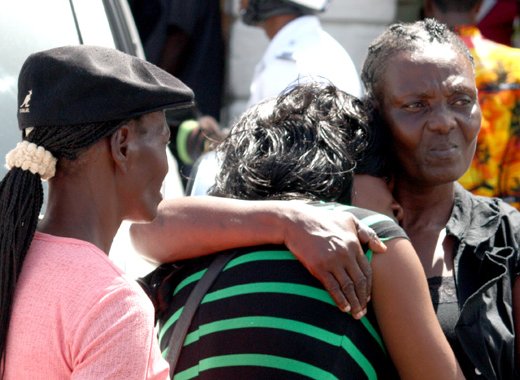 The mother of murder victim Stephanie Daniel (centre) consoles another of her daughters outside the High Court in Kingstown on Friday, June 7, 2013. (IWN photo)