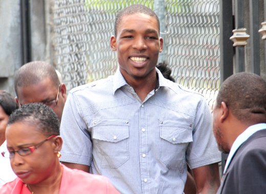 In this June 2013 file photo, Collin "Cocoa" David, centre, arrives at court to hear an attempted murder and robbery charge. He got his first conviction on Thursday, when he was found guilty of gun and ammunition possession. (IWN photo)