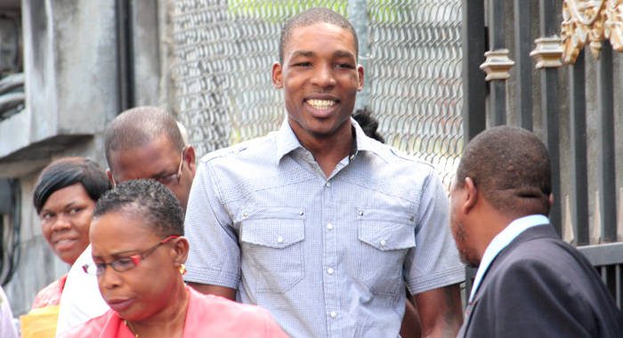 In this June 2013 file photo, Collin "Cocoa" David, centre, arrives at court to hear an attempted murder and robbery charge. He got his first conviction on Thursday, when he was found guilty of gun and ammunition possession. (IWN photo)