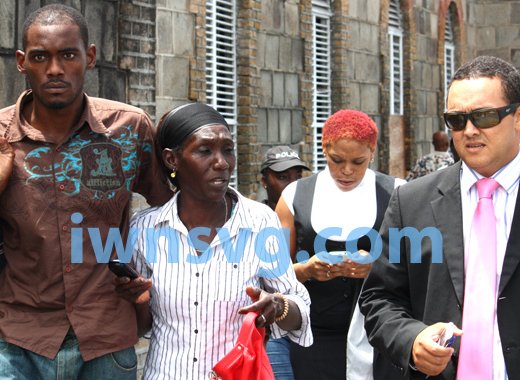 Dwaine Sandy, left, is seen with his mother, Margaret Sandy, and lawyer, Grant Connell, shortly after Sandy was released from police custody on Wednesday, June 19, 2013. (IWN photo)