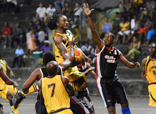 Ishama McKree of Calliaqua United attempts a basket amidst tough defence from Bequia United in the finals of the Mens Basketball Championship at the New Montrose Basketball Facility on Sunday, June 16, 2012. (Photo: Edward Newman)