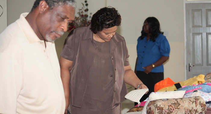 Permanent Secretary in the Ministry of Education, Nicole Bonadie Baker, right, and Senior Education Officer, Zan George, look at some of the items made by the graduates. (IWN photo)