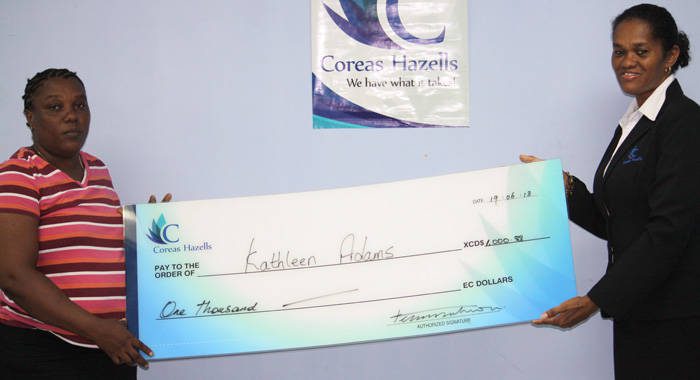 Kathleen Daniel-Adams, mother of Shelisa Adams receives cheque from Divisional Manager-Retail of Coreas Hazells Inc., Debbie Huggins.