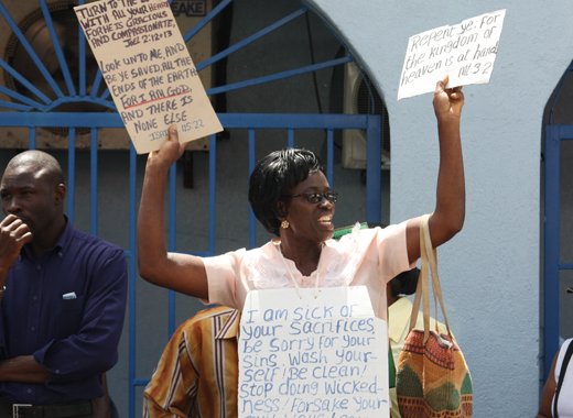 A woman holds placards with Scripture verses written on them at the National Day of Prayer Rally in Kingstown on Monday, June 10, 2013. (IWN photo)