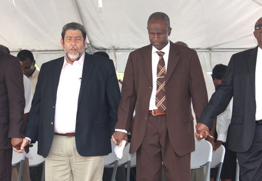From left: Chair of the National Day of Prayer Committee, Rev. Kelron Harry, Prime Minister Dr. Ralph Gonsalves, Minister of National Mobilisation, Maxwell Charles, and Opposition Leader Arnhim Eustace hold hands during prayer at the National Day of Prayer Rally in Kingstown, on Monday, June 10, 2013.