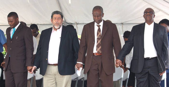 From left: Chair of the National Day of Prayer Committee, Rev. Kelron Harry, Prime Minister Dr. Ralph Gonsalves, Minister of National Mobilisation, Maxwell Charles, and Opposition Leader Arnhim Eustace hold hands during prayer at the National Day of Prayer Rally in Kingstown, on Monday, June 10, 2013.