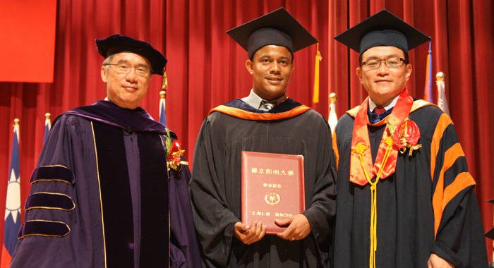 Dr. Rosmond Adams, centre, and officials of the National Yang-Ming University in Taiwan . 