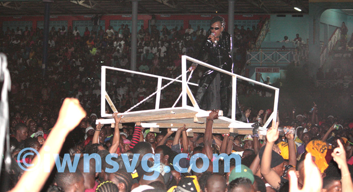 Fya Empress is carried aloft on top a platform to the stage. 