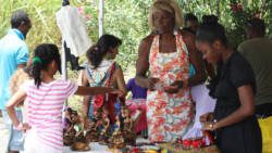 Artisans and visitors to the cultural festival interact on Saturday. (IWN photo)  