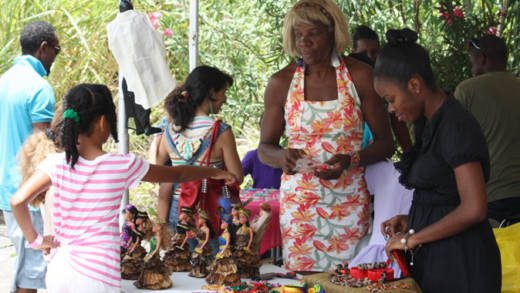 Artisans and visitors to the cultural festival interact on Saturday. (IWN photo)  