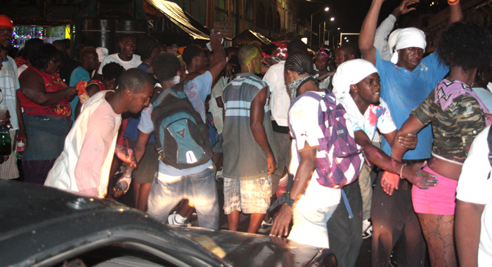 A car negotiates its way through Kingstown as the streets began to fill up with revellers for J'ouvert during the pre-dawn hours of Monday, July 8, 2013. (IWN photo) 