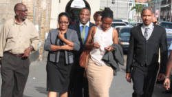 Opposition senator, Vynnette Frederick, second from left, leaves the Central Police Station in Kingstown on Thursday, July 11, 2013, in the company of her lawyers and Vice-President of the New Democratic Party, St. Clair Leacock, left. (IWN photo)