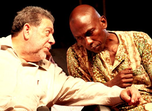 Prime Minister Dr. Ralph Gonsalves, right, and Sen. Jomo Thomas chat at the opening of the Regional Reparations Conference in Kingstown on Sunday, Sept. 15th, 2013. (IWN photo)