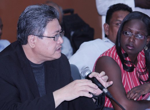 Orisha Joseph of Sustainable Grenadines Inc. listens as a Jamaican participant makes an intervention. 