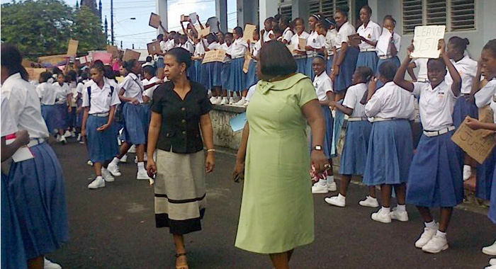 Teachers walk outside SJCK on Monday as students protest. (Internet photo)