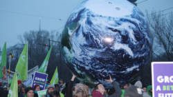 Environmentalists demonstrate in Warsaw on Saturday. Caribbean negotiators are in a precarious position as Japans revised its reduction emissions target. 