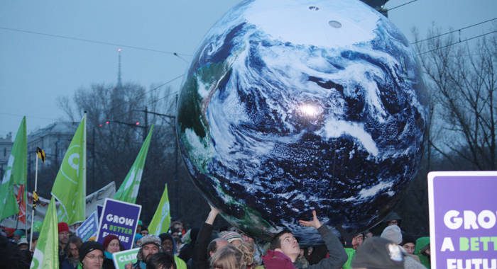 Environmentalists demonstrate in Warsaw on Saturday. Caribbean negotiators are in a precarious position as Japans revised its reduction emissions target. 
