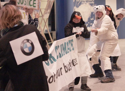 Young activists stage a mock tug-of-war at the climate talks to demonstrate the conflicting interest of big business and the environment. (IWN photo)