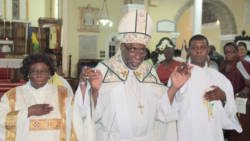 The Right Reverend C. Leopold Friday, bishop of the Winward Islands, centre, and newly ordained deacons, Hanif H.R. Johnson, right and Alison M. Samuel during the recession. (IWN photo)