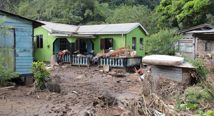 Floodwaters have damaged or destroyed many houses, like this one in Spring Village, N. Leeward. (IWN photo)