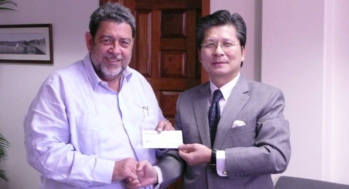 Ambassador Shih, right,  presents a cheque for US$200,000 to PM Gonsalves.