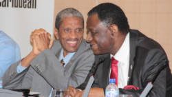 Dr. Douglas Slater of CARICOM, left, chats with head of the UN's population agency, Dr. Babatunde Osotimehin at the consultation. (IWN photo)