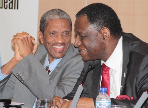Dr. Douglas Slater of CARICOM, left, chats with head of the UN's population agency, Dr. Babatunde Osotimehin at the consultation. (IWN photo)
