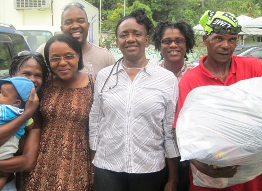 Members of the Thusia SDA church with one of the shelter managers, Ms  Mcdowall, center,  and a survivor assisting her in Buccament  Bay. (DRP photo)