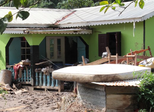 A mattress damaged by floodwaters stand outside a house in Spring Village. PM Gonsalves says a wealthy businessman will donate 1,000 mattresses to persons affected by the 24/12/13 disaster. (IWN photo)   