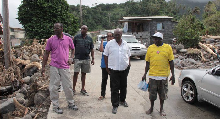 Opposition Leader Arnhim Eustace, centre, and other members of the NDP visit North Windward after the Christmas disaster.(IWN file photo)
