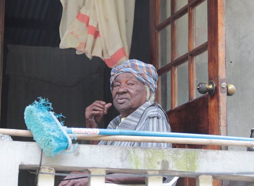 As PM Gonsalves toured North Leeward on Dec. 27, 2013, this woman, tells journalist Kenton X. Chance to put her name at the top of the list of persons to receive aid. PM Gonsalves has called for swift action to help the suffering. (IWN photo)