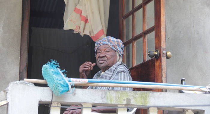 As PM Gonsalves toured North Leeward on Dec. 27, 2013, this woman, tells journalist Kenton X. Chance to put her name at the top of the list of persons to receive aid. PM Gonsalves has called for swift action to help the suffering. (IWN photo)