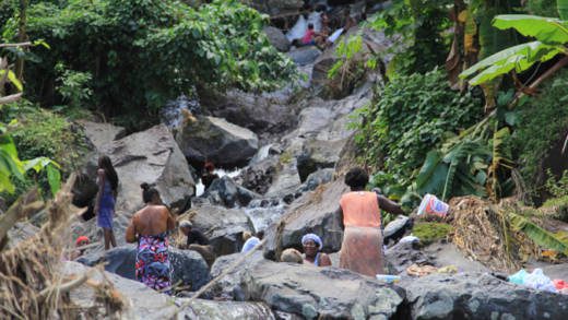 Residents of North Windward bathe in a river on Tuesday, Dec. 31, 2013. Water was yet to be reconnected there, one week after the disaster. (IWN photo)