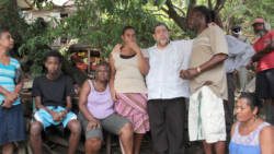 Prime Minister Ralph Gonsalves visits a family in Rose Bank where five persons died on Christmas Eve. (IWN photo)