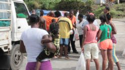 Residents of Fancy collect "ration", disaster relief from ECGC on Tuesday. PM Gonsalves says  the 24/12/13 disaster as resulted in two SVGs. (IWN photo)