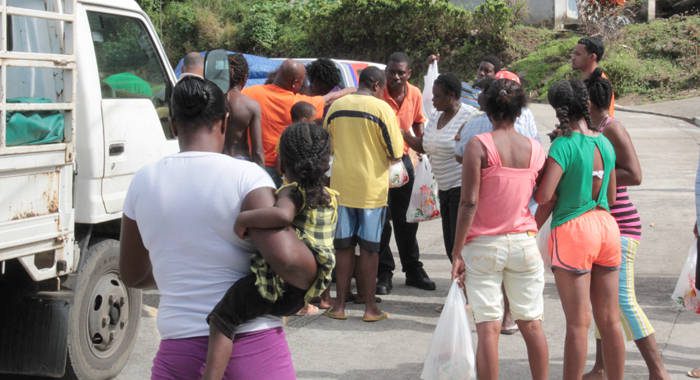 Residents of Fancy collect "ration", disaster relief from ECGC on Tuesday. PM Gonsalves says  the 24/12/13 disaster as resulted in two SVGs. (IWN photo)