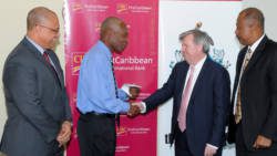 Project lead Wayne Charles-Soverall, expresses his gratitude to Chief Executive Officer, CIBC FirstCaribbean, Rik Parkhill, while Director of the Comtrust Board & Managing Director Retail & Business Banking, Mark St. Hill and Principal and Pro-Vice-Chancellor of the UWI Cave Hill Campus, Professor Sir Hilary Beckles, look on.