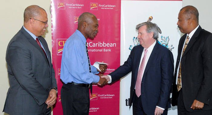 Project lead Wayne Charles-Soverall, expresses his gratitude to Chief Executive Officer, CIBC FirstCaribbean, Rik Parkhill, while Director of the Comtrust Board & Managing Director Retail & Business Banking, Mark St. Hill and Principal and Pro-Vice-Chancellor of the UWI Cave Hill Campus, Professor Sir Hilary Beckles, look on.