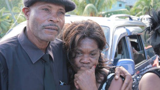 Stella James is consoled after the funeral service of her daughter, flood victim Keslia James on Saturday, Jan. 4, 2014. (IWN photo) 