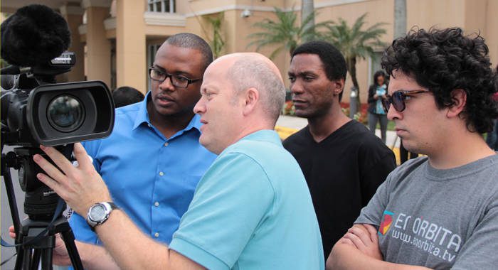 Facilitator Kevin Fogarty, centre, and participants interact during the Making Video News course in Miami. (IWN photo) 