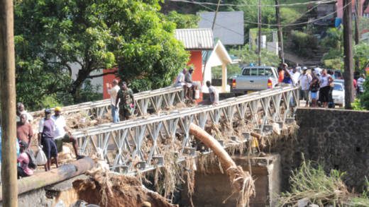 A large logs sticks out of a bridge in North Leeward. (IWN photo)