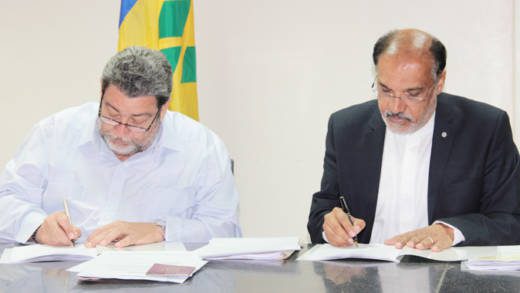 Prime Minister Ralph Gonsalves, left, and Deep Ford of the FAO sign a grant agreement this week. (IWN photo)