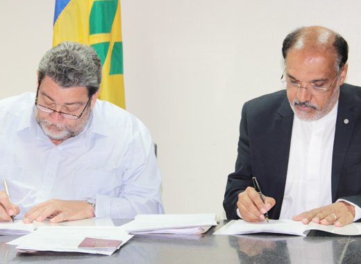 Prime Minister Ralph Gonsalves, left, and Deep Ford of the FAO sign a grant agreement this week. (IWN photo)