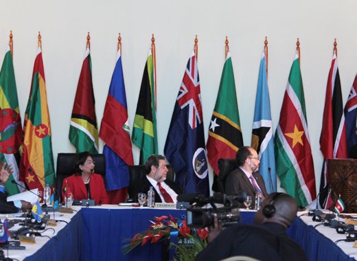 From left: Outgoing chair of CARICOM, Kamla Persad- Bissessar, Prime Minster of Trinidad and Tobago, Chair of CAIRCOM, Prime Minister of St. Vincent and the Grenadines, Ralph Gonsalves, and   CARICOM Secretary General, Irwin LaRocque react as Vincentian musician Rodney Small plays pan at the opening of the CARICOM meeting on Monday. (IWN Photo) 
