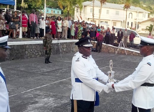 Commissioner of Police Michael Charles presents and award at Thursday's Passing Out Parade. (Photo: Owen Baptiste)