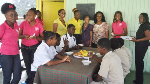 Principal of Intermediate High School, Bernadette Slater-Peters, (in black), Coordinating Teacher, Kimberley Young-Compton Young-Compton, third from right, and other teachers and young leaders.
