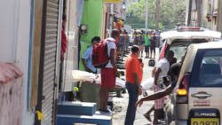 The body of Kwesi Ryan is removed from the scene in Paul's Avenue on Monday. (IWN image)
