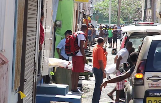 The body of Kwesi Ryan is removed from the scene in Paul's Avenue on Monday. (IWN image)