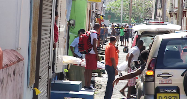 The body of Kwesi Ryan is removed from the scene in Paul's Avenue on Monday. (IWN image)